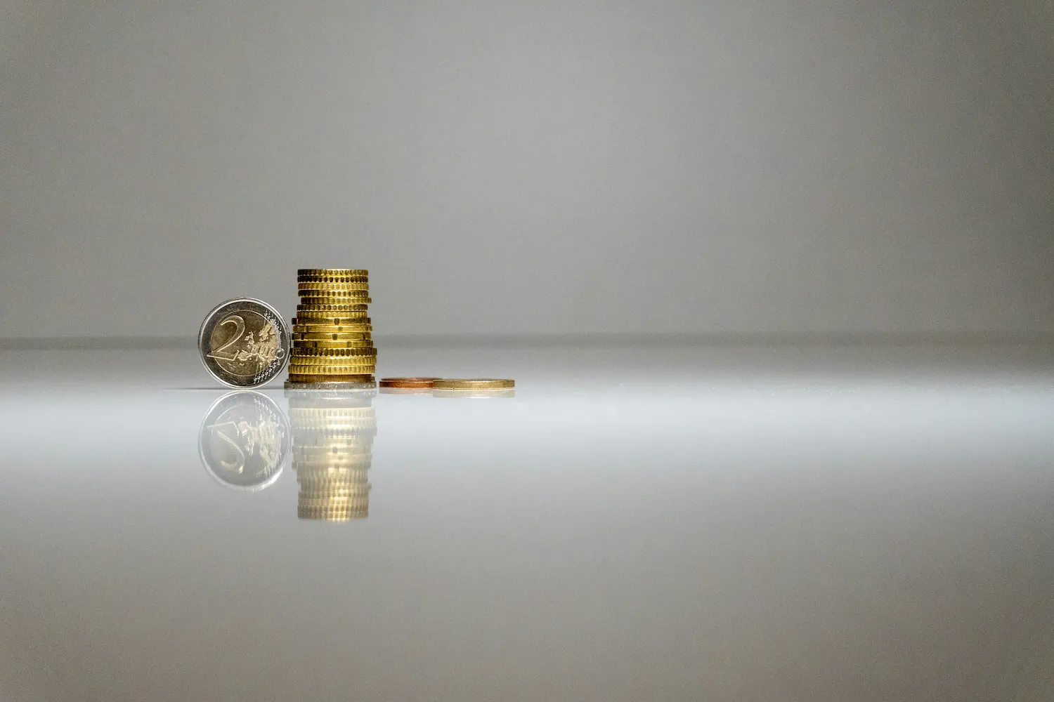 image title A single coin separated from a pile of coins, representing the profit a business retains from each sale
