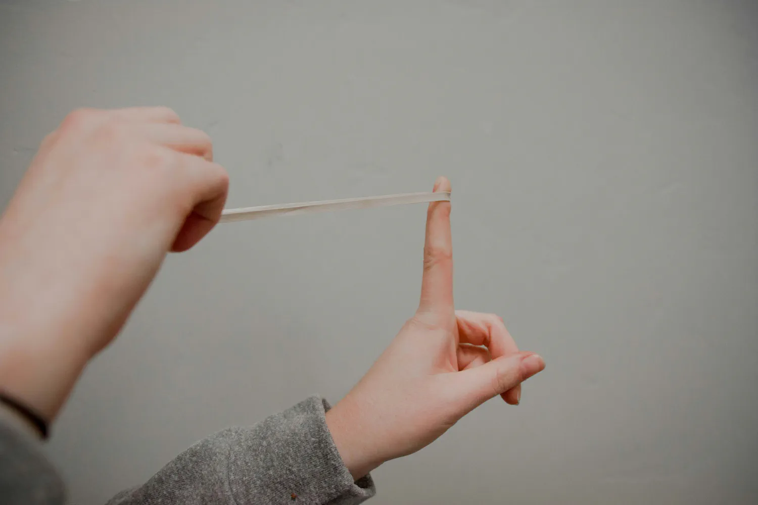 A rubber band stretched and ready to snap back, representing mean reversion in a stock's valuation